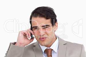 Close up of annoyed salesman on his cellphone