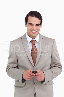 Smiling salesman holding his cellphone