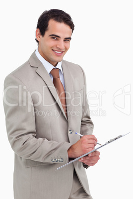 Smiling salesman with notepad and pen