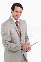 Smiling salesman with notepad and pen