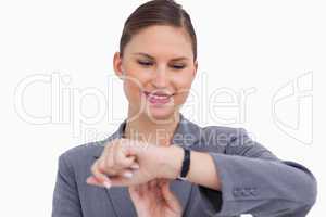 Smiling businesswoman checking her watch