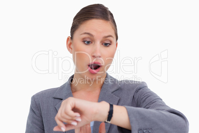 Surprised businesswoman checking her watch