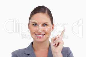 Close up of smiling tradeswoman pointing up