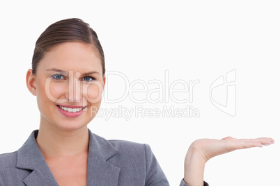 Close up of smiling tradeswoman holding her palm up