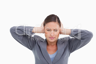 Close up of annoyed tradeswoman covering her ears