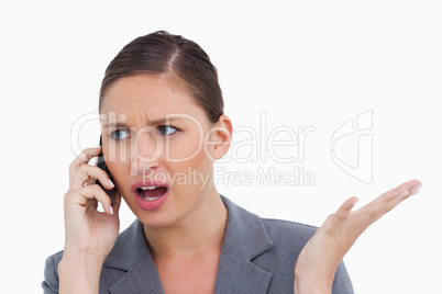 Close up of irritated tradeswoman on her cellphone