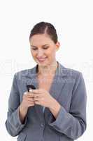 Close up of smiling tradeswoman reading text message