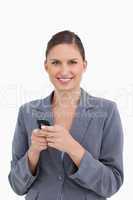 Close up of smiling tradeswoman holding cellphone