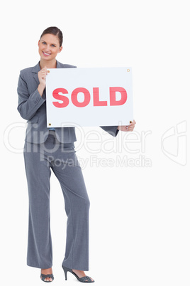 Happy real estate agent with sold sign