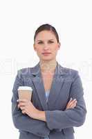 Tradeswoman with arms folded and paper cup