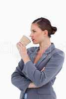 Side view of tradeswoman taking a sip out of her paper cup