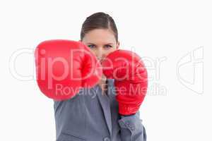 Tradeswoman with boxing gloves attacking