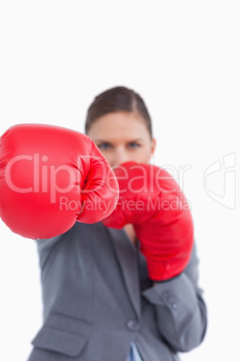 Attacking fist of tradeswoman in boxing glove