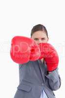 Tradeswoman with boxing gloves attacking with right fist
