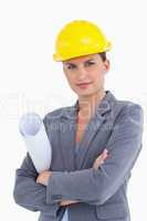 Close up of female architect with helmet and plans