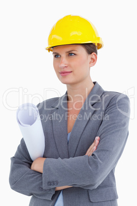 Female architect with plans and helmet on