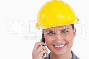 Close up of smiling female architect on her cellphone