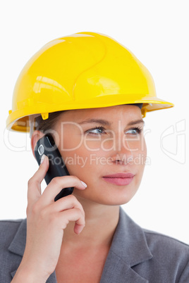 Close up of female architect on her cellphone with helmet on