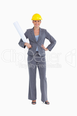 Smiling female architect with plans and helmet on