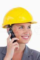 Close up of female architect with cellphone and helmet on