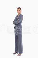 Side view of smiling tradeswoman with her arms folded