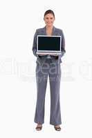Smiling tradeswoman presenting her laptop screen