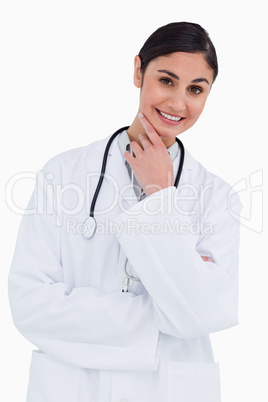 Smiling female doctor in thinkers pose