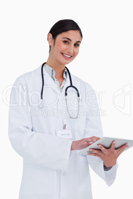 Side view of smiling female doctor with tablet computer