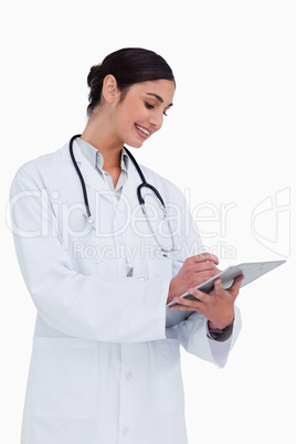 Side view of female doctor taking notes