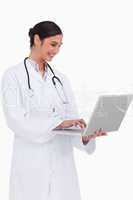 Side view of smiling doctor with her laptop