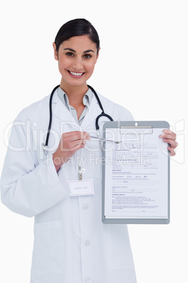 Smiling female doctor pointing at form