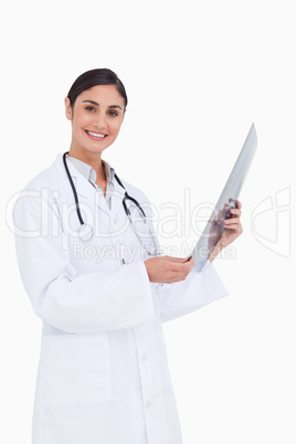 Side view of smiling female doctor with x-ray