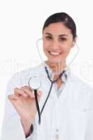 Close up of stethoscope being used by female doctor