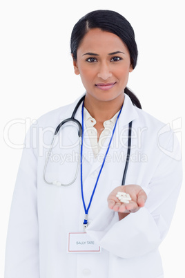 Close up of female physician holding pills in her palm