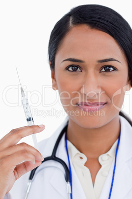 Close up of female physician with syringe