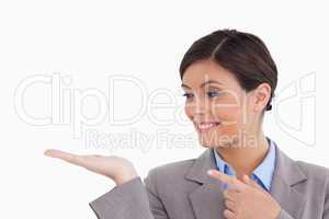 Close up of female entrepreneur looking and pointing at her palm