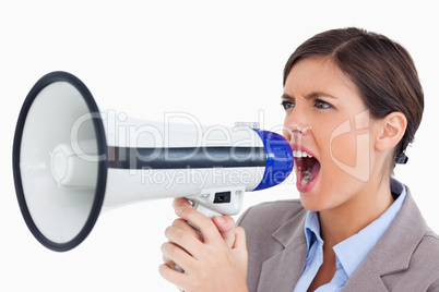 Close up of female entrepreneur yelling through megaphone