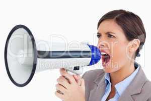 Close up of female entrepreneur yelling through megaphone