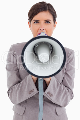 Close up of female entrepreneur shouting through megaphone