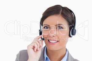 Close up of smiling female call center agent adjusting her heads