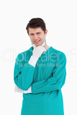 Close up of male doctor wearing scrubs in thinkers pose