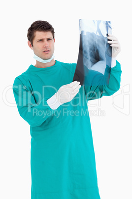 Close up of serious looking doctor with x-ray