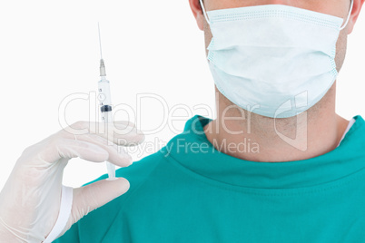 Close up of doctor with syringe wearing scrubs