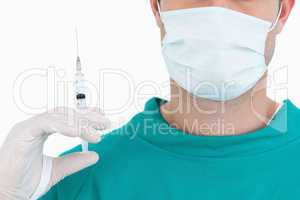 Close up of male doctor with syringe wearing scrubs