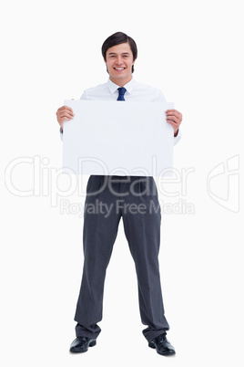 Smiling tradesman holding blank sign