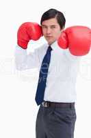 Attacking fist of tradesman in boxing glove