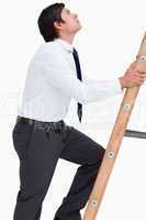 Side view of tradesman climbing a ladder