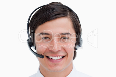 Close up of smiling male call center agent with headset on