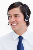 Close up of smiling male call center agent looking to the side