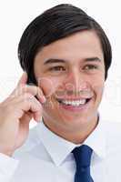 Close up of smiling tradesman on his cellphone